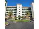 Beautiful condo building with classic design, lush landscaping, and roundabout entrance at 4801 Osprey S Dr # 209, St Petersburg, FL 33711