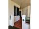 Exterior hallway with red tile flooring leading to a unit door at 4801 Osprey S Dr # 209, St Petersburg, FL 33711
