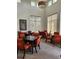 Bright game room with multiple game tables, chairs, and large windows for natural light at 4801 Osprey S Dr # 209, St Petersburg, FL 33711