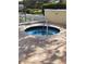 Outdoor hot tub with brick surround, offering a private and serene relaxation experience at 4801 Osprey S Dr # 209, St Petersburg, FL 33711