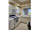 Kitchen with white cabinets, featuring a microwave, stove and oven at 4801 Osprey S Dr # 209, St Petersburg, FL 33711