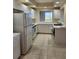Spacious kitchen with white cabinets, featuring a refrigerator, stove, oven and dishwasher at 4801 Osprey S Dr # 209, St Petersburg, FL 33711
