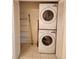 A laundry room with stacked washer and dryer and shelving at 4801 Osprey S Dr # 209, St Petersburg, FL 33711