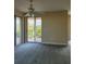 Living room featuring sliding glass doors to balcony, ceiling fan, and neutral walls at 4801 Osprey S Dr # 209, St Petersburg, FL 33711