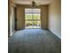 Living room featuring wall to wall carpet, a ceiling fan and a large window at 4801 Osprey S Dr # 209, St Petersburg, FL 33711
