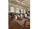 A spacious lounge area featuring multiple seating arrangements, hard wood floors and large windows for natural light at 4801 Osprey S Dr # 209, St Petersburg, FL 33711