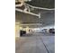 View of parking garage with multiple parking spaces and visible piping on the ceiling at 4801 Osprey S Dr # 209, St Petersburg, FL 33711