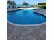 Community swimming pool with plenty of seating surrounded by lush landscaping at 4801 Osprey S Dr # 209, St Petersburg, FL 33711