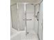 Walk-in shower with grab bars and glass door in renovated bathroom at 4801 Osprey S Dr # 209, St Petersburg, FL 33711