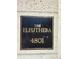 Close-up of a decorative plaque showing the building name and address: The Eleuthera 4801 at 4801 Osprey S Dr # 209, St Petersburg, FL 33711