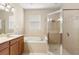 Bathroom featuring double sinks, a tub, and a separate glass shower at 5236 Clover Mist Dr, Apollo Beach, FL 33572