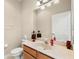 Clean bathroom with a single sink vanity, toilet, and large mirror at 5236 Clover Mist Dr, Apollo Beach, FL 33572