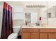 Bathroom featuring double sinks, decorative shower curtain, and plenty of counter space at 5236 Clover Mist Dr, Apollo Beach, FL 33572