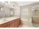 Bathroom featuring double sinks, a tub, and a separate glass shower at 5236 Clover Mist Dr, Apollo Beach, FL 33572