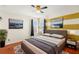 Bright bedroom featuring hardwood floors, modern furniture, and decorative striped wall at 5236 Clover Mist Dr, Apollo Beach, FL 33572