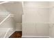 Spacious walk-in closet with wood flooring and ample shelving for organization at 5236 Clover Mist Dr, Apollo Beach, FL 33572