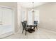 Bright dining area features chandelier lighting and natural light from the door and window at 5236 Clover Mist Dr, Apollo Beach, FL 33572