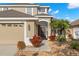 Close-up of the front exterior showing the tasteful landscaping, front door, and two-car garage at 5236 Clover Mist Dr, Apollo Beach, FL 33572