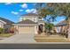 Beautiful front exterior of a two-story home featuring a well manicured lawn, tasteful landscaping, and a two-car garage at 5236 Clover Mist Dr, Apollo Beach, FL 33572
