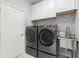 Laundry room with modern appliances, ample counter space, and cabinet storage at 5236 Clover Mist Dr, Apollo Beach, FL 33572