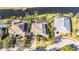 Aerial view of a home featuring a waterfront canal, private dock and screened pool at 5326 Loon Nest Ct, Apollo Beach, FL 33572