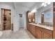 Elegant bathroom with double vanity, granite countertops, and a glass-enclosed shower for a luxurious feel at 5326 Loon Nest Ct, Apollo Beach, FL 33572
