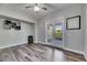 Bedroom with neutral walls, wood-look floors, and french doors to the patio at 5326 Loon Nest Ct, Apollo Beach, FL 33572