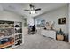 Cozy bedroom featuring built-in shelves, a work desk, and a ceiling fan at 5326 Loon Nest Ct, Apollo Beach, FL 33572