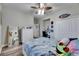Bedroom featuring hardwood floors, ceiling fan, dresser, and closet space at 5326 Loon Nest Ct, Apollo Beach, FL 33572