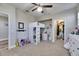 Bright bedroom with a bed and desk area, open closet, and closet space for ample storage at 5326 Loon Nest Ct, Apollo Beach, FL 33572