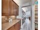 Spacious butler pantry featuring custom cabinetry, granite countertops, and easy access to the kitchen and dining areas at 5326 Loon Nest Ct, Apollo Beach, FL 33572