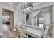 Open-concept dining room features decorative lighting, stairs and wood-look flooring at 5326 Loon Nest Ct, Apollo Beach, FL 33572
