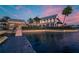 Waterfront view of a house and dock showcasing beautiful architecture and landscaping and adjacent waterway at 5326 Loon Nest Ct, Apollo Beach, FL 33572