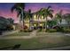 Beautiful two-story home featuring tropical landscaping, brick pathway, lush grass, and a two-car garage at 5326 Loon Nest Ct, Apollo Beach, FL 33572