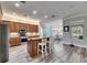 Open kitchen with wooden cabinets, stainless steel appliances, and a breakfast bar with views to dining area at 5326 Loon Nest Ct, Apollo Beach, FL 33572