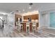 Spacious kitchen boasts a large island with seating, wooden cabinets, and modern stainless steel appliances at 5326 Loon Nest Ct, Apollo Beach, FL 33572