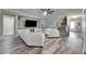 Spacious living room with wood-look flooring, built-in shelving, and a cozy sectional sofa at 5326 Loon Nest Ct, Apollo Beach, FL 33572