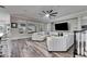 Spacious living room with wood-look flooring, built-in shelving, and a cozy sectional sofa at 5326 Loon Nest Ct, Apollo Beach, FL 33572
