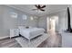 Bright main bedroom with wood floors, modern ceiling fan, and ample closet space at 5326 Loon Nest Ct, Apollo Beach, FL 33572