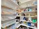 Well-organized pantry offers ample storage with wire shelving, maximizing space for food and household items at 5326 Loon Nest Ct, Apollo Beach, FL 33572