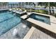 Luxurious pool and spa with water features, and a paver deck at 5326 Loon Nest Ct, Apollo Beach, FL 33572