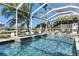 Enclosed pool area with heated pool, hot tub, water features and beautiful canal view at 5326 Loon Nest Ct, Apollo Beach, FL 33572