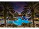 A beautiful community pool with a lighthouse water slide feature at dusk with dramatic sky colors at 5326 Loon Nest Ct, Apollo Beach, FL 33572