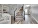 Staircase and entryway featuring hardwood floors and white trim at 5326 Loon Nest Ct, Apollo Beach, FL 33572