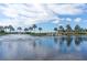 Scenic water view showcasing fountain, palm trees, and a bridge on a beautiful day with some clouds at 5326 Loon Nest Ct, Apollo Beach, FL 33572