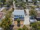 An aerial view of a charming home with a metal roof, detached garage and outdoor firepit area at 6131 Central Ave, New Port Richey, FL 34653