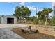 Landscaped backyard with a seating area and a storage structure, perfect for outdoor gatherings and relaxation at 6131 Central Ave, New Port Richey, FL 34653
