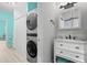 Bathroom featuring a vanity with a sink, a mirror, and a laundry area with appliances at 6131 Central Ave, New Port Richey, FL 34653