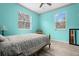 Stylish blue bedroom with light wood floors, two windows, and lots of natural light at 6131 Central Ave, New Port Richey, FL 34653