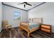 Bedroom with wood floors, a ceiling fan, a window with blinds, and neutral walls at 6131 Central Ave, New Port Richey, FL 34653